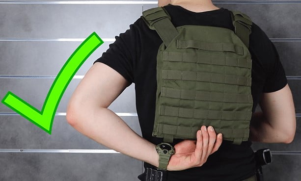 A man trying to fit the plate carrier